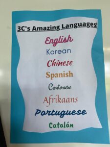 Classroom display listing students’ languages including English, Korean, Chinese, Spanish, Cantonese, Afrikaans, Portuguese, and Catalan.
